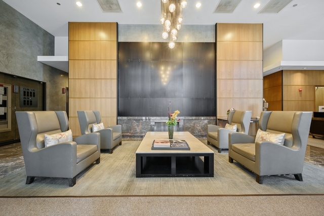 450 East Waterside Drive, Unit 2902 Chicago, IL 60601 - Photo 30 of 44 a living room with furniture and a fireplace