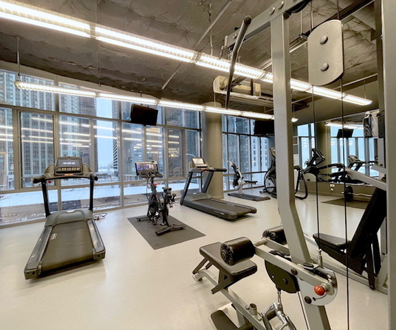 450 East Waterside Drive, Unit 2902 Chicago, IL 60601 - Photo 34 of 44 a view of a livingroom with gym equipment