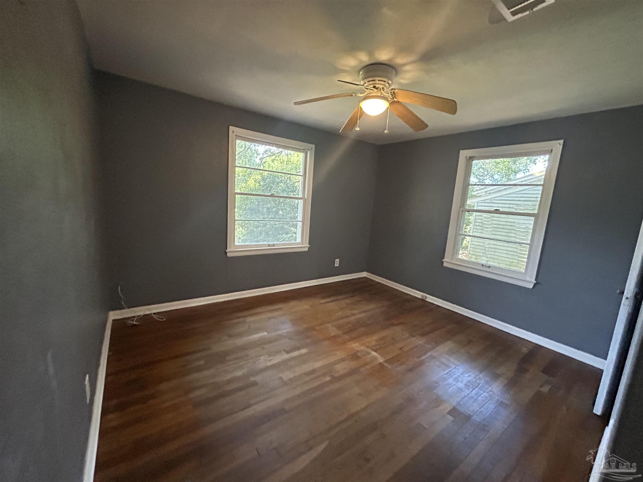 210 Milton Road Pensacola, FL 32507 - Photo 15 of 17 a view of an empty room with wooden floor and a window
