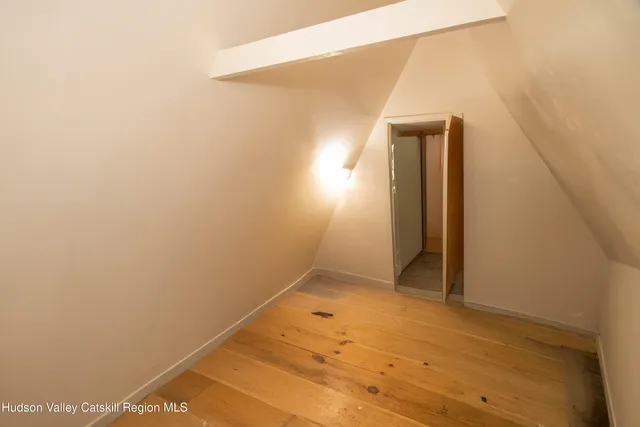 a kitchen with cabinets and wooden floor