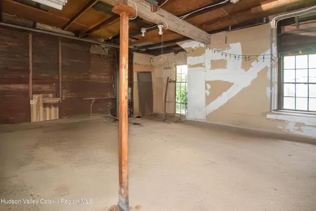 a spacious bedroom with a bed and a window