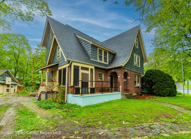 a front view of a house with a yard table and chairs
