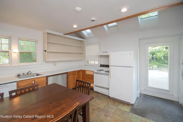 a kitchen with stainless steel appliances granite countertop a sink a stove and a refrigerator