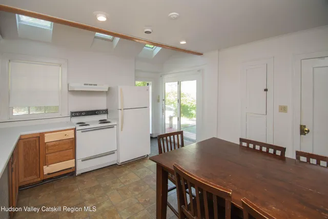 a kitchen with a table chairs sink and cabinets