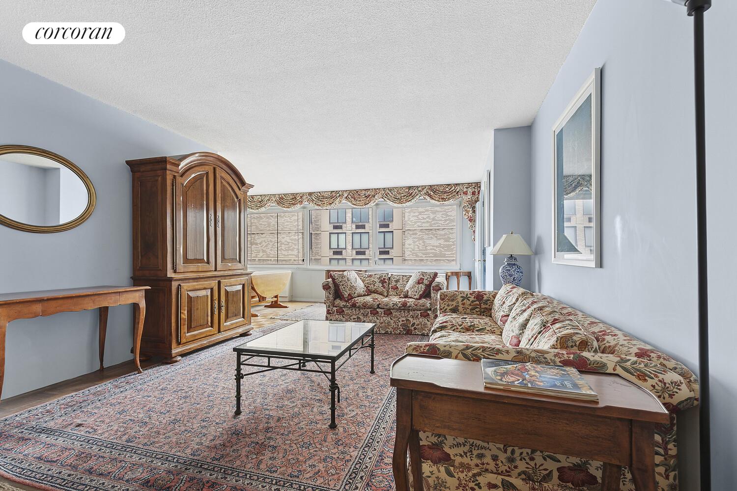 a living room with furniture a rug and a window