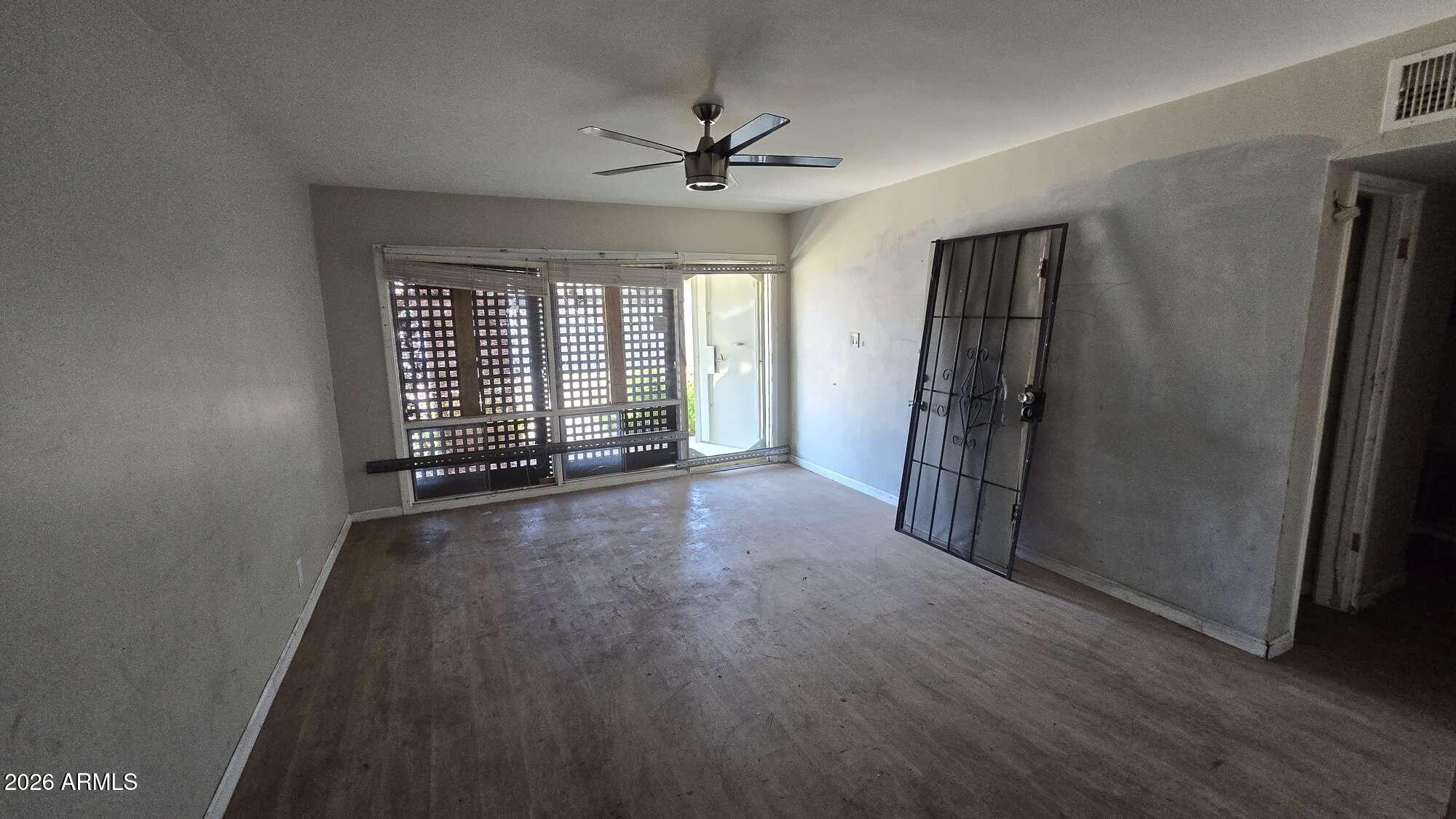 834 West Osborn Road Phoenix, AZ 85013 - Photo 27 of 45 an empty room with wooden floor and windows