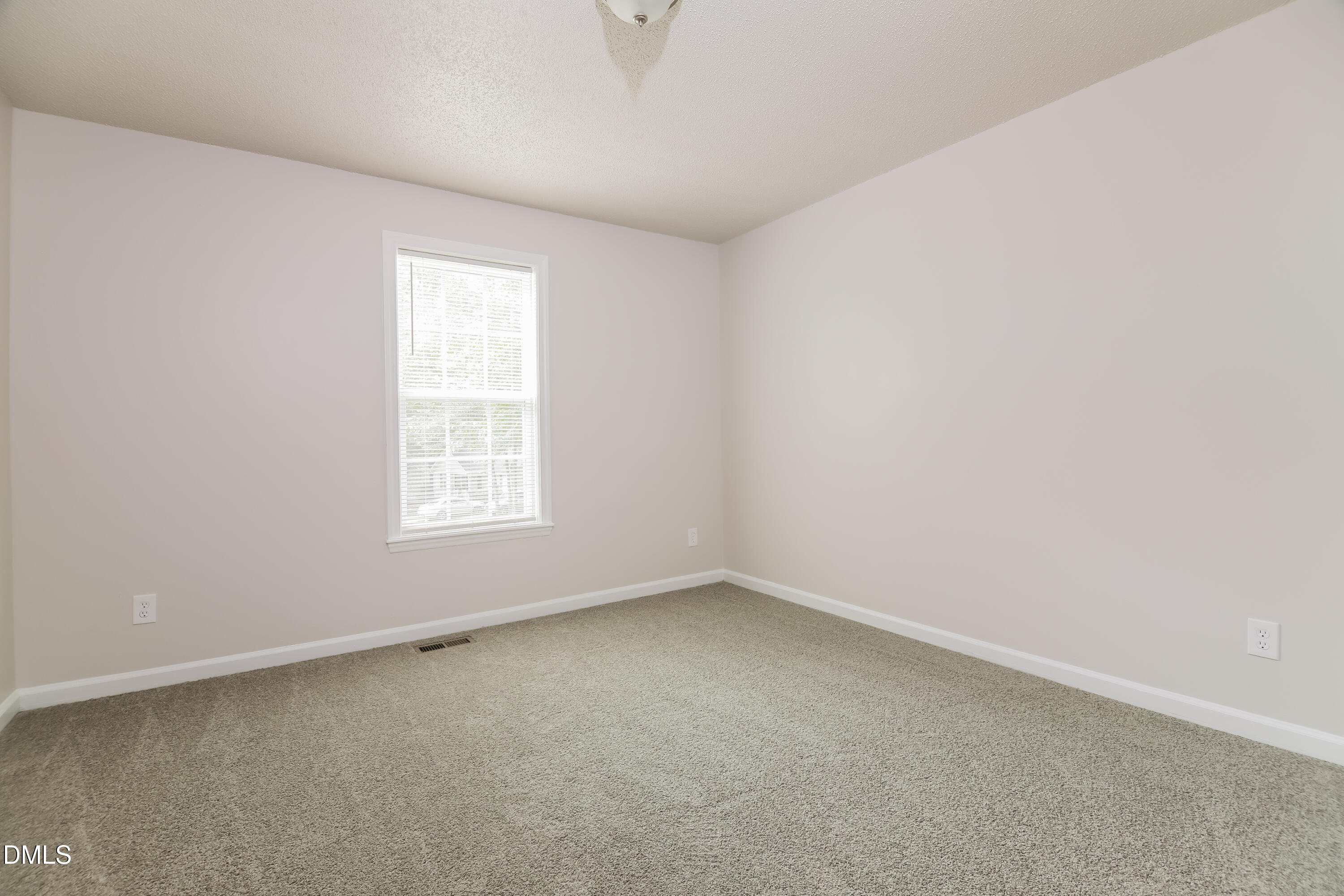5201 Pronghorn Lane Raleigh, NC 27610 - Photo 12 of 16 an empty room with a window