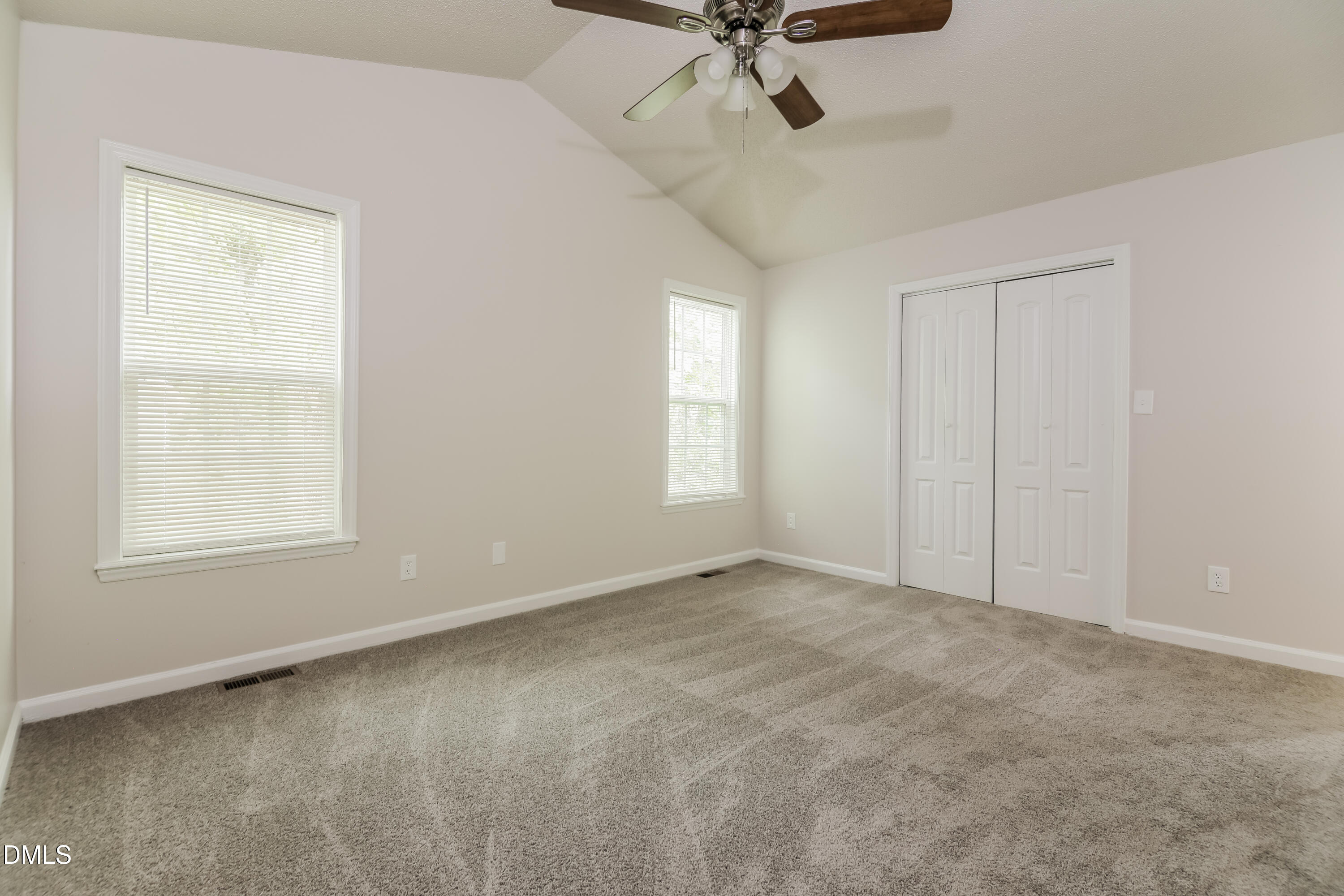 5201 Pronghorn Lane Raleigh, NC 27610 - Photo 8 of 16 an empty room with a window and a fan