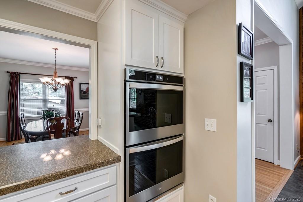 9024 Random Road Waxhaw, NC 28173 - Photo 14 of 48 a kitchen with granite countertop white cabinets and stainless steel appliances