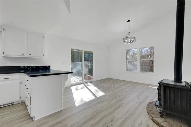 a living room with hard wood floors and a window