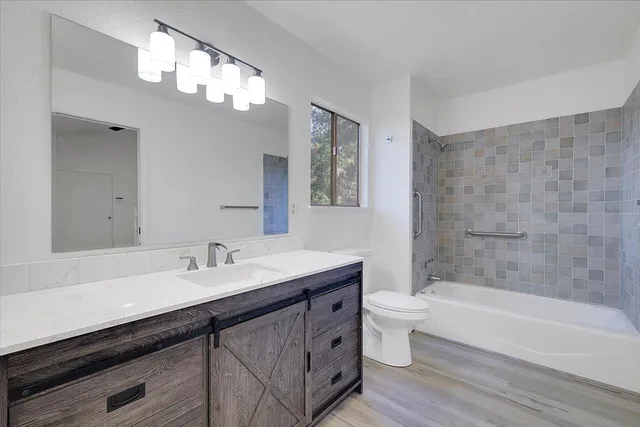 a bathroom with a double vanity sink mirror and toilet
