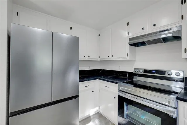 a kitchen with stainless steel appliances a refrigerator and a stove