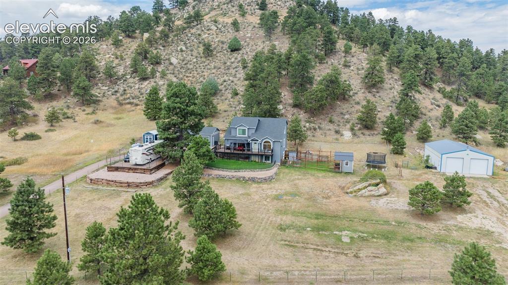 A turn key 5 ACRE retreat... private and perfect with nice home, several outbuildings including the HUGE shop. Beautiful setting with character of land, lots of trees and everything you are looking for.