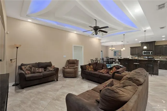 a living room with furniture and a ceiling fan