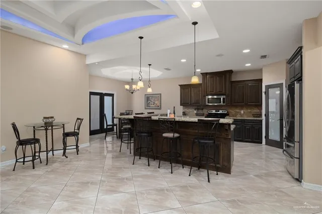 a kitchen with a dining table chairs and a counter top space