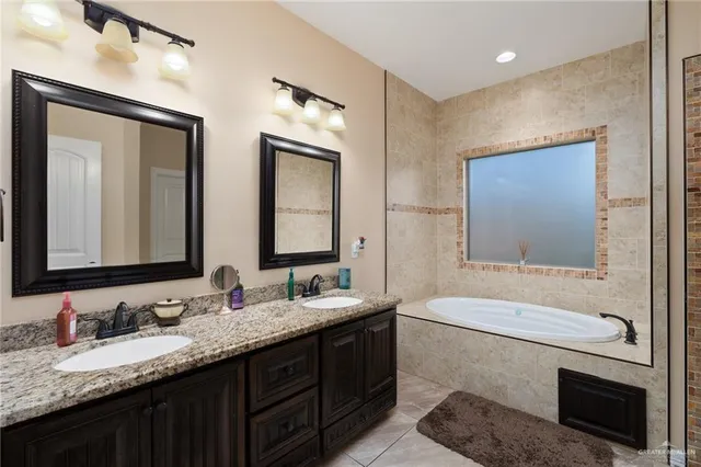 a bathroom with a double vanity sink and a mirror