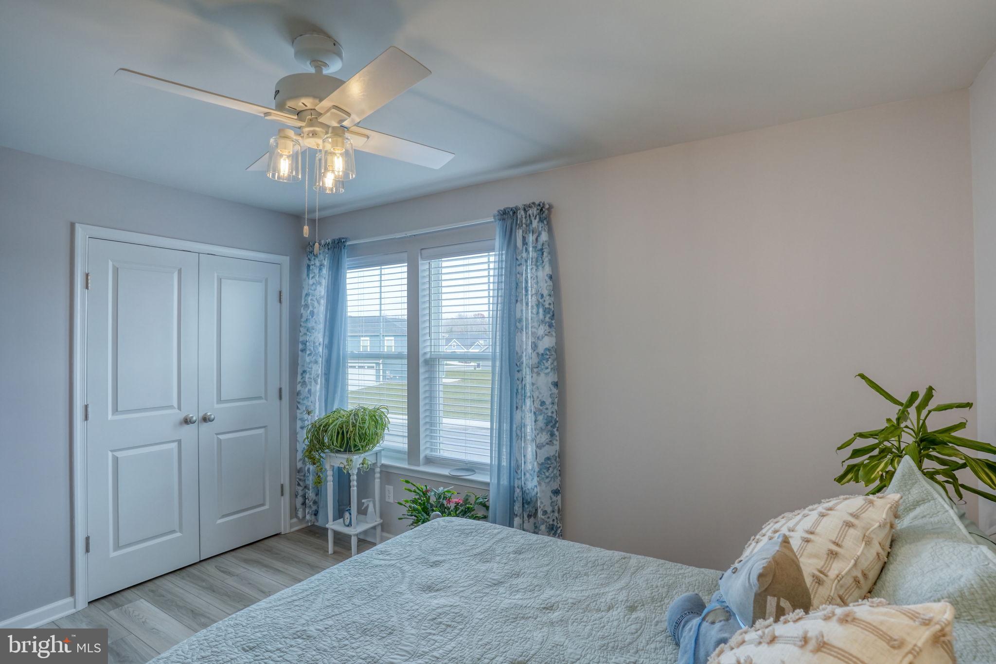 653 Cpl Rodney Wayne Wilson Loop Georgetown, DE 19947 - Photo 33 of 55 a bedroom with a bed and a chandelier