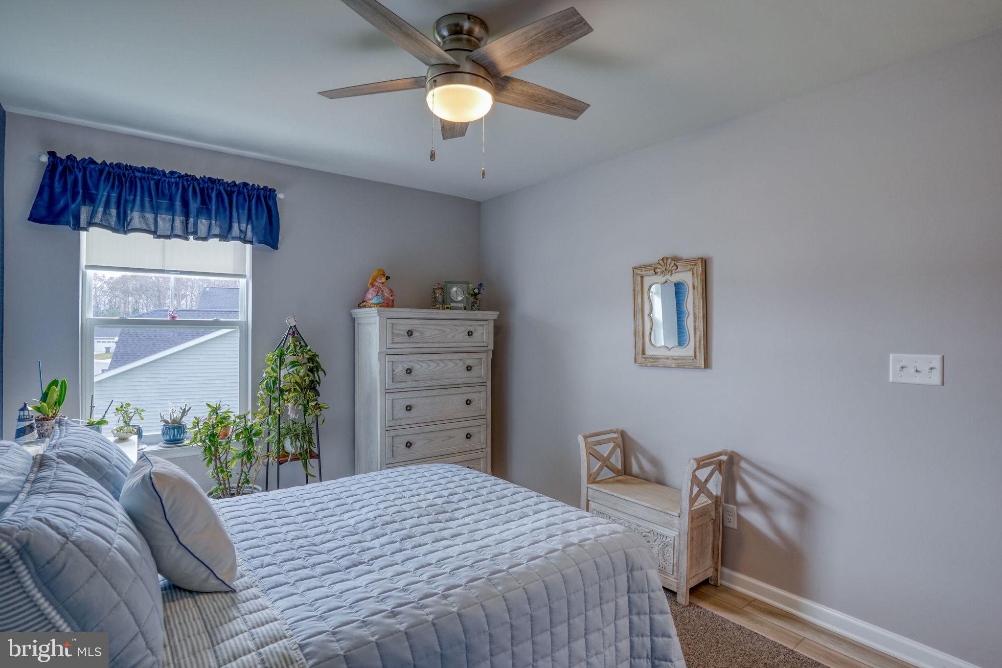 653 Cpl Rodney Wayne Wilson Loop Georgetown, DE 19947 - Photo 36 of 55 a bedroom with a bed and a chandelier