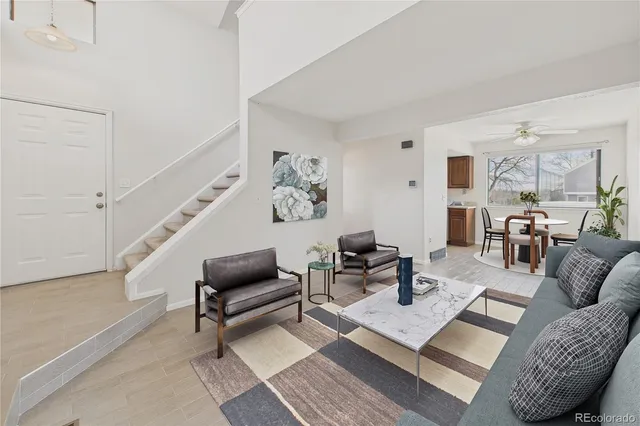 a living room with furniture and wooden floor