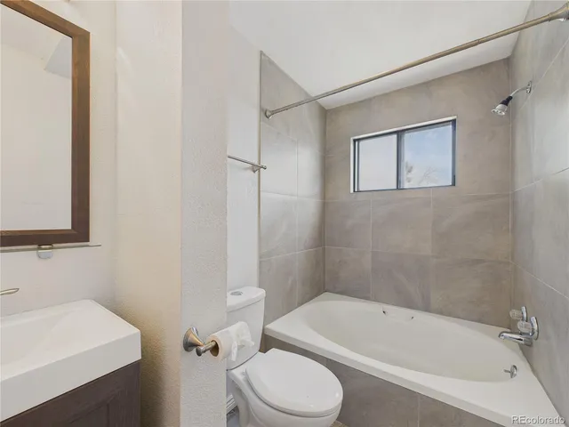 a bathroom with a toilet a sink and bathtub