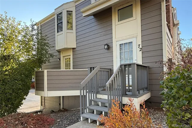 a view of a patio with table and chairs with wooden fence and plants