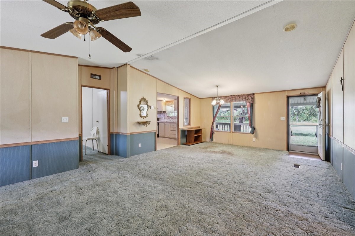 6505 County Road 200 Brookeland, TX 75931 - Photo 11 of 34 a view of a livingroom with a chandelier fan and windows
