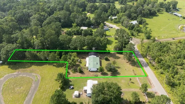 an aerial view of a residential houses with outdoor space and swimming pool