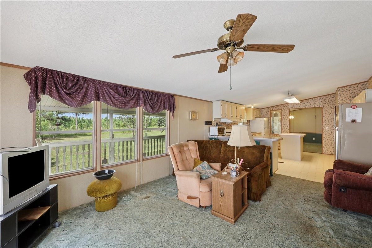6505 County Road 200 Brookeland, TX 75931 - Photo 21 of 34 a living room with furniture and a floor to ceiling window