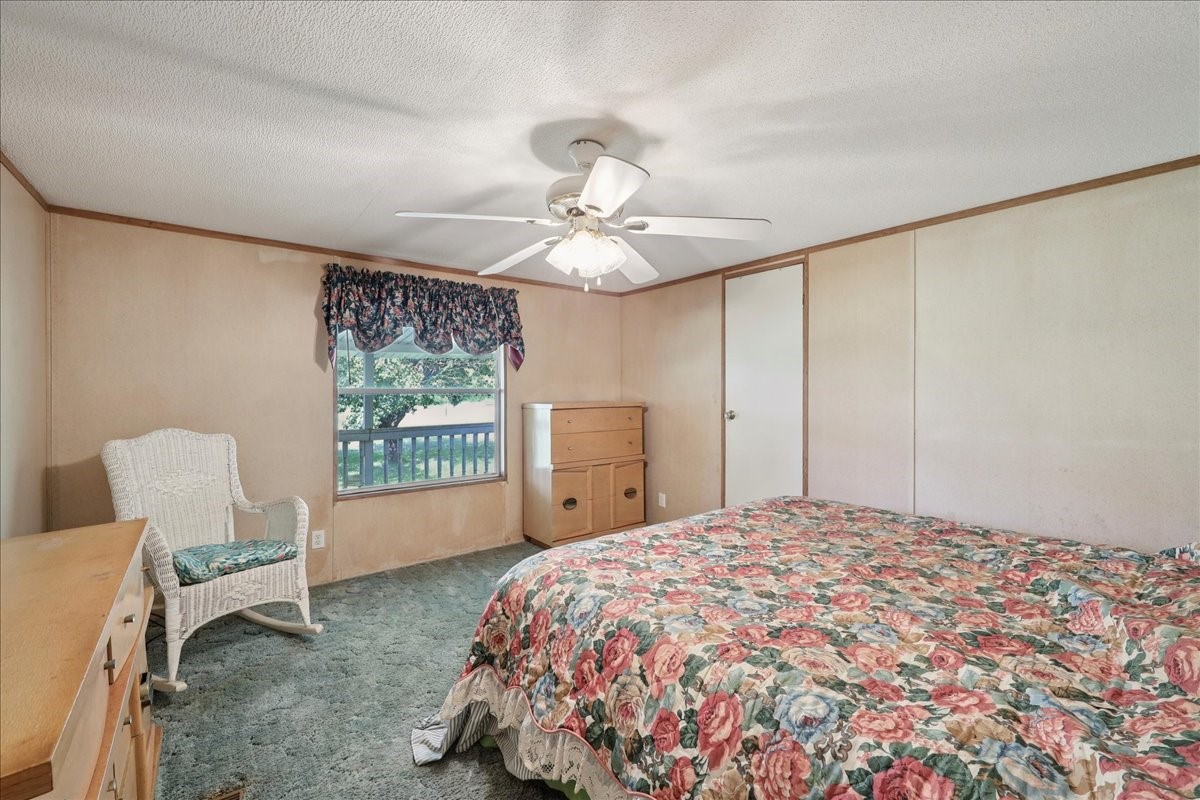 6505 County Road 200 Brookeland, TX 75931 - Photo 27 of 34 a bedroom with a bed and a chair