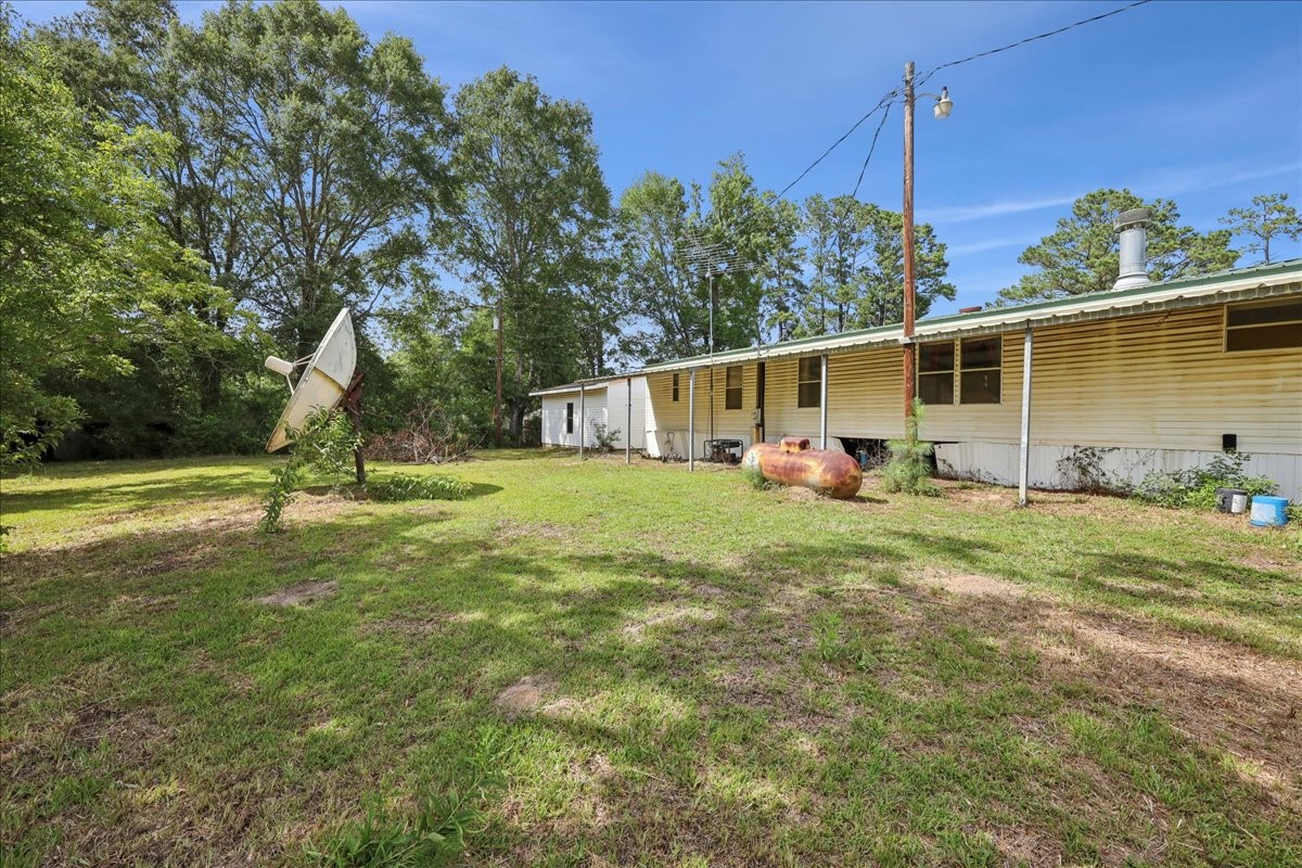 6505 County Road 200 Brookeland, TX 75931 - Photo 33 of 34 a view of a house with backyard and a tree