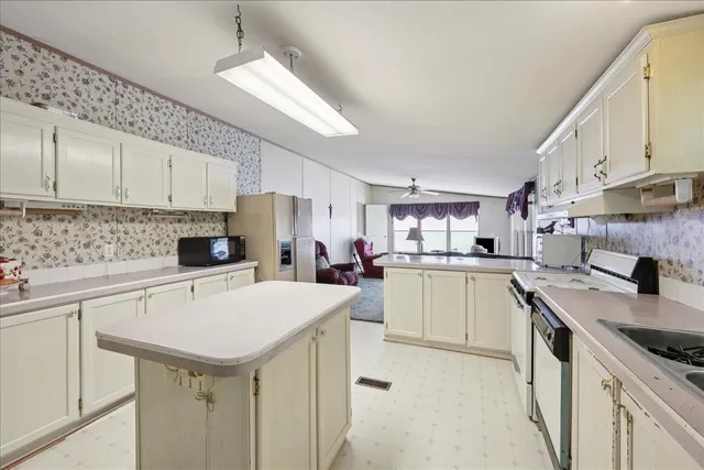 a kitchen with a sink a stove and cabinets