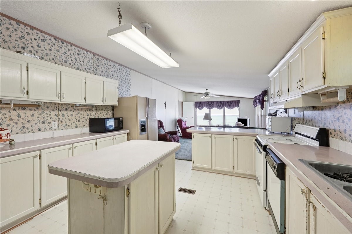 6505 County Road 200 Brookeland, TX 75931 - Photo 5 of 6 a kitchen with a sink a stove and cabinets