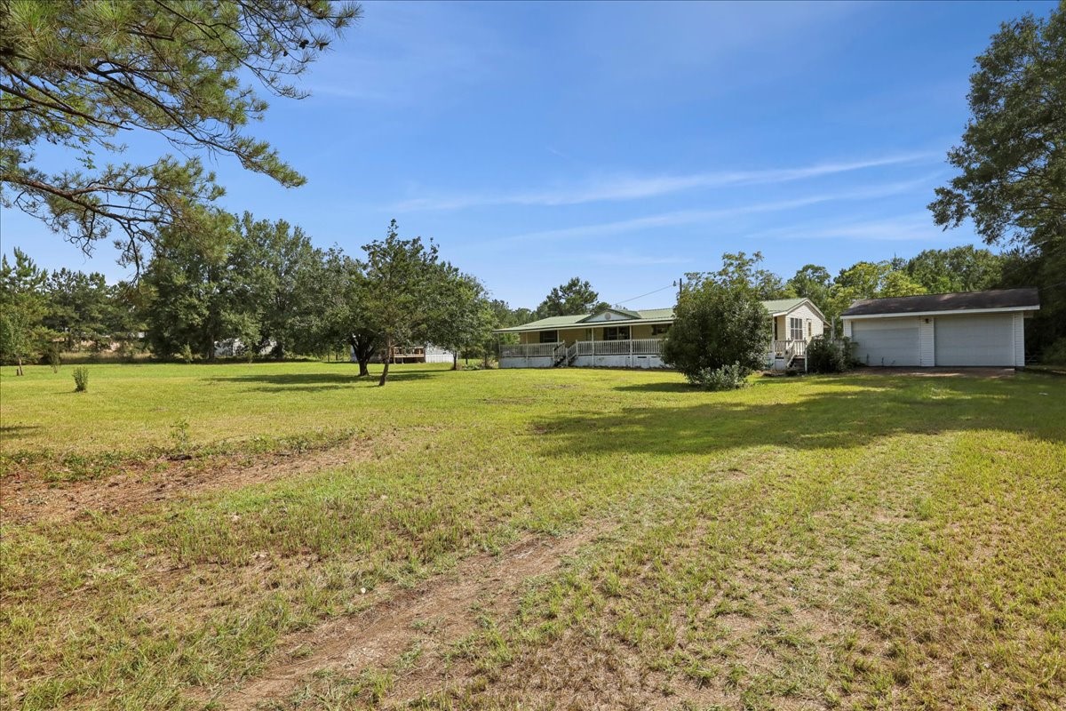 6505 County Road 200 Brookeland, TX 75931 - Photo 6 of 34 a view of a green field with wooden fence