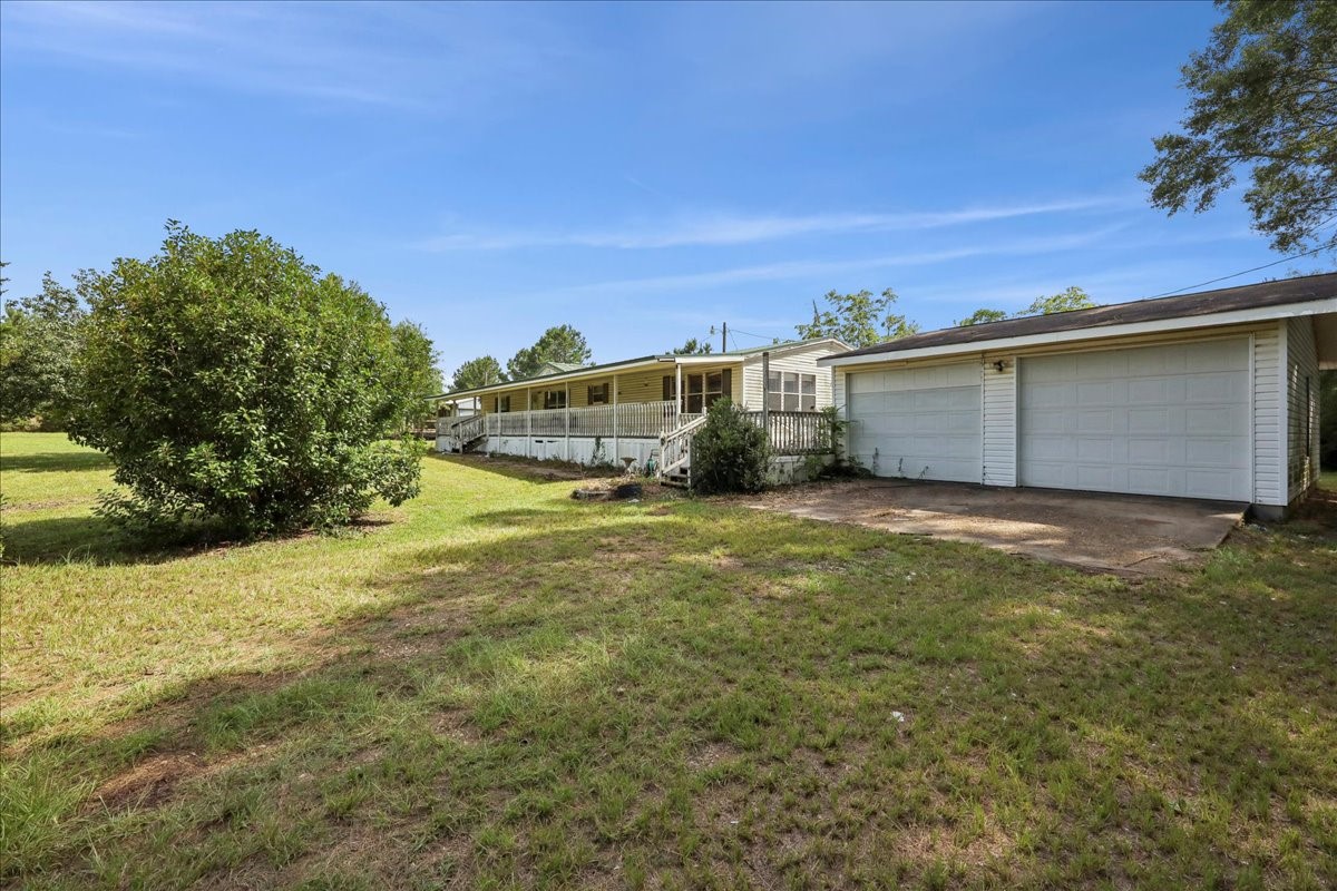 6505 County Road 200 Brookeland, TX 75931 - Photo 7 of 34 a view of a backyard of the house