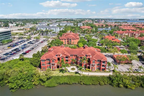 an aerial view of residential houses with outdoor space and trees