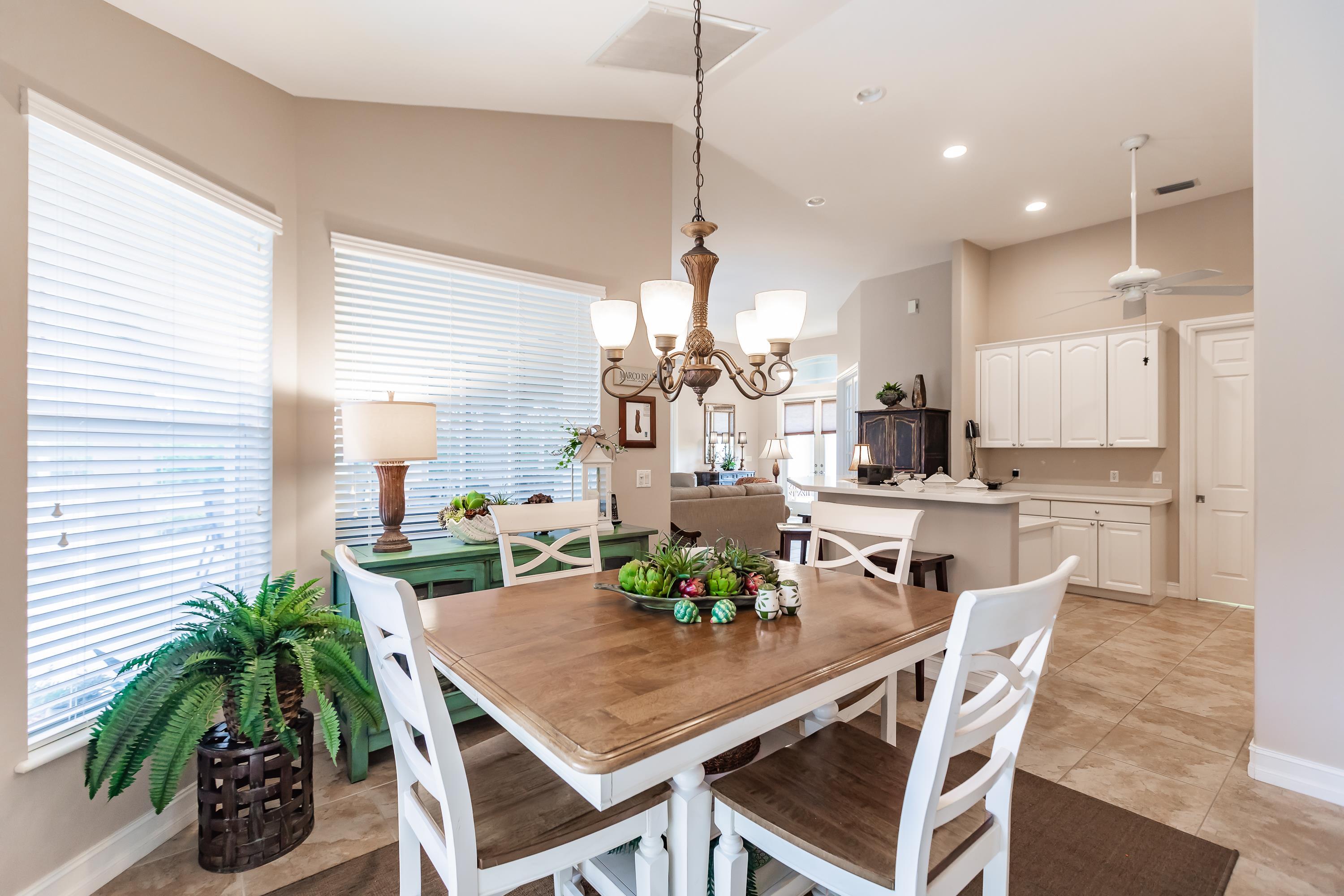 31 Tahiti Road Marco Island, FL 34145 - Photo 14 of 31 a view of a dining room with furniture and a potted plant