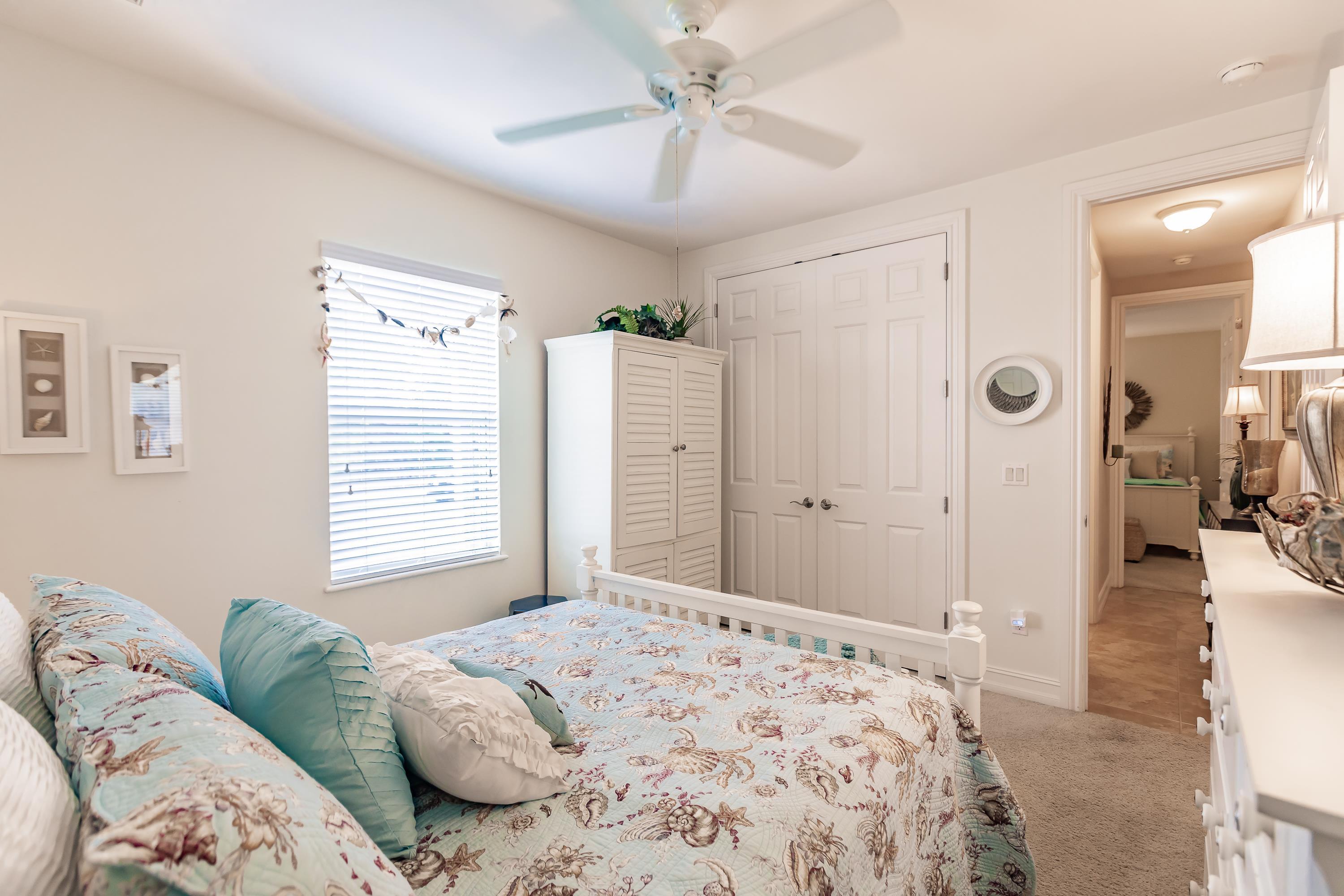 31 Tahiti Road Marco Island, FL 34145 - Photo 21 of 31 a bedroom with a bed and a chandelier
