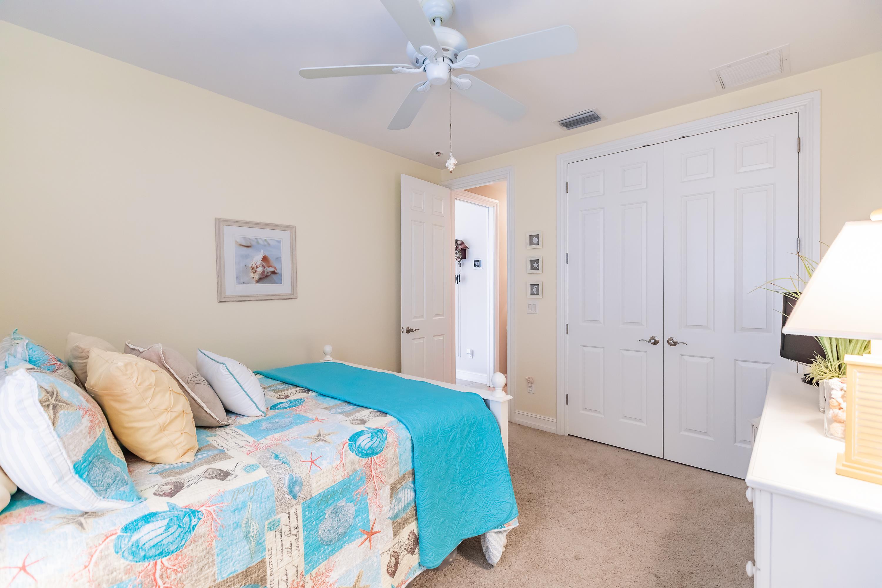 31 Tahiti Road Marco Island, FL 34145 - Photo 23 of 31 a bedroom with a bed and a chandelier