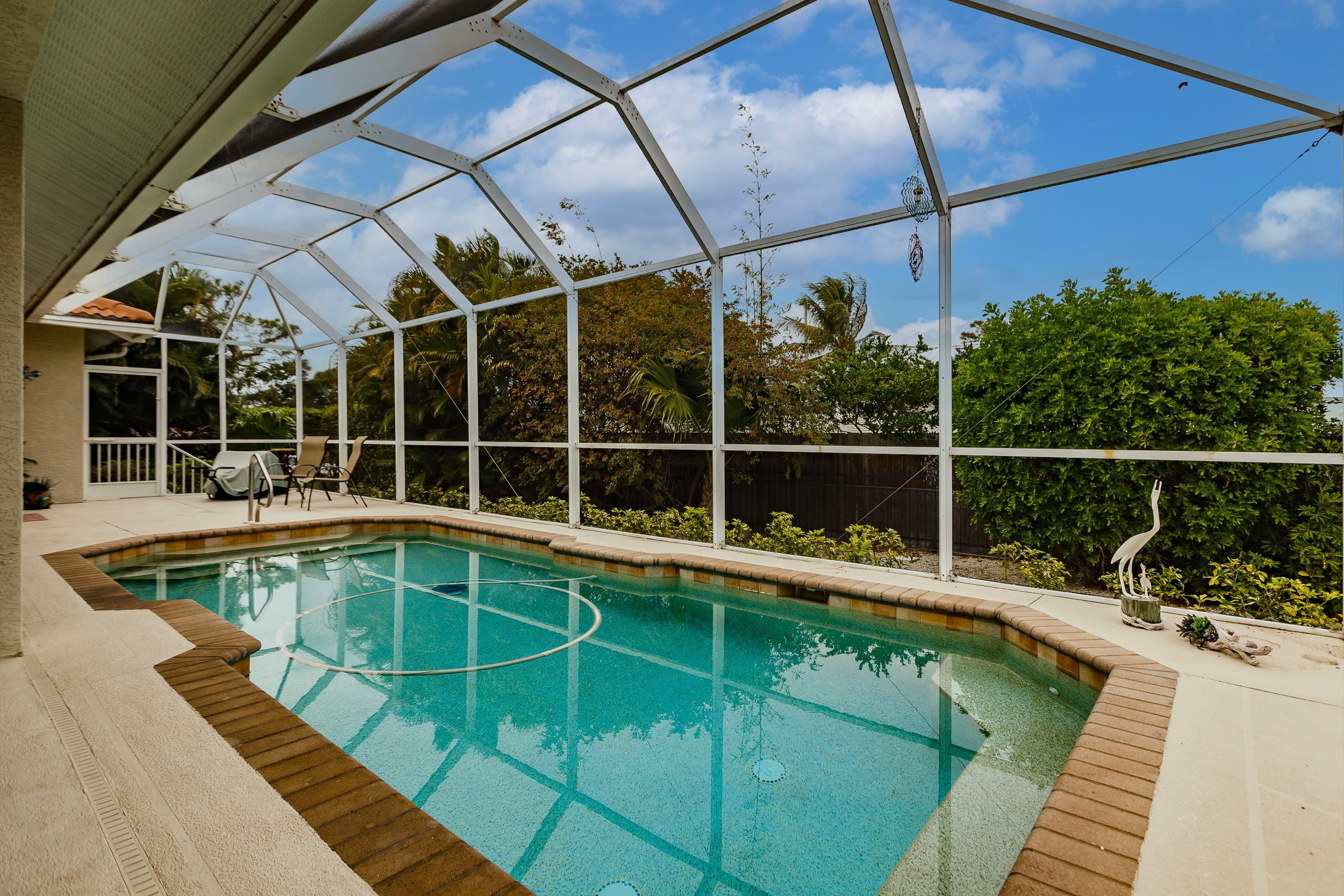31 Tahiti Road Marco Island, FL 34145 - Photo 28 of 31 a view of a swimming pool with a patio and yard of the house