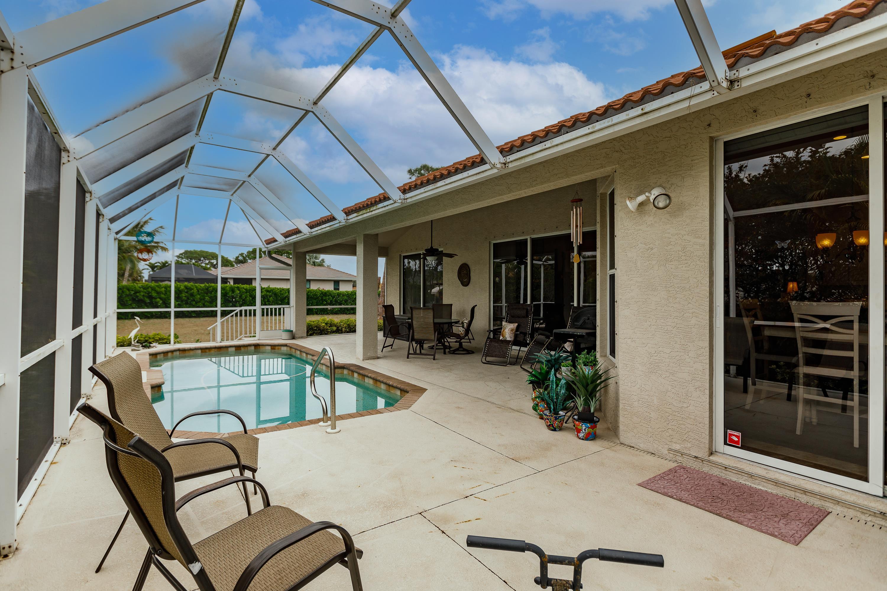 31 Tahiti Road Marco Island, FL 34145 - Photo 29 of 31 a view of a house with backyard porch and sitting area