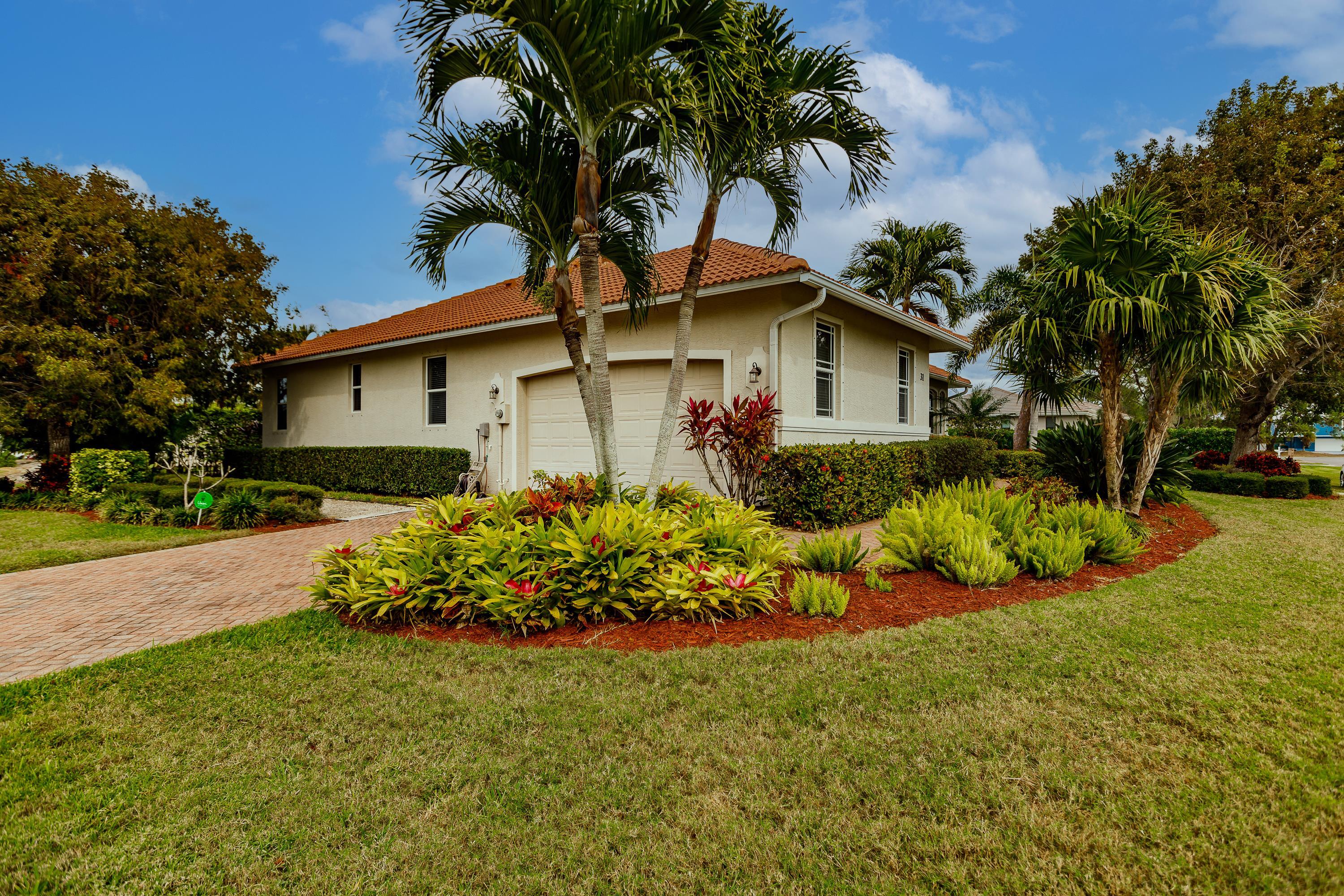 31 Tahiti Road Marco Island, FL 34145 - Photo 3 of 31 a front view of a house with a garden