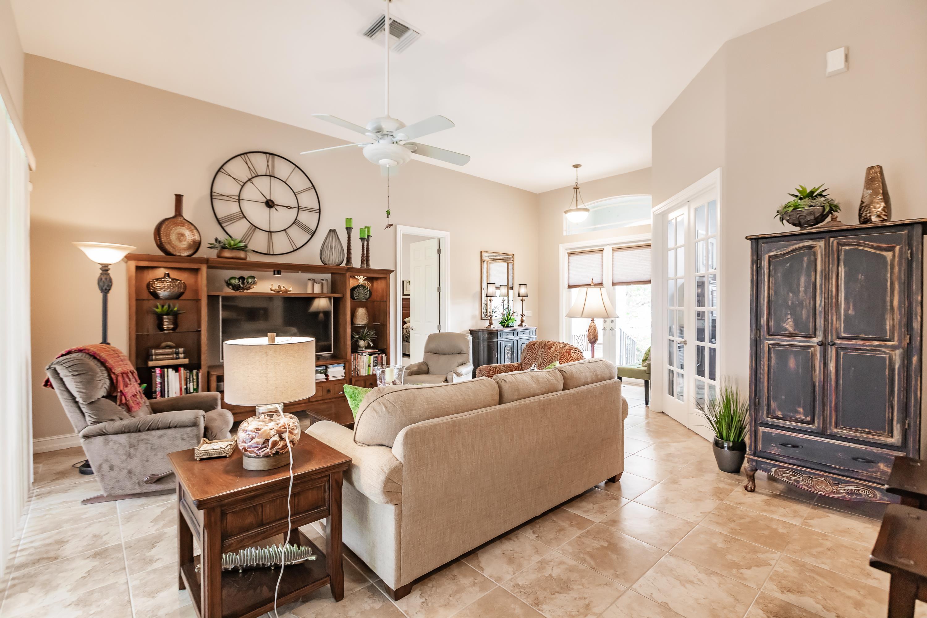 31 Tahiti Road Marco Island, FL 34145 - Photo 7 of 31 a living room with furniture a window and a clock