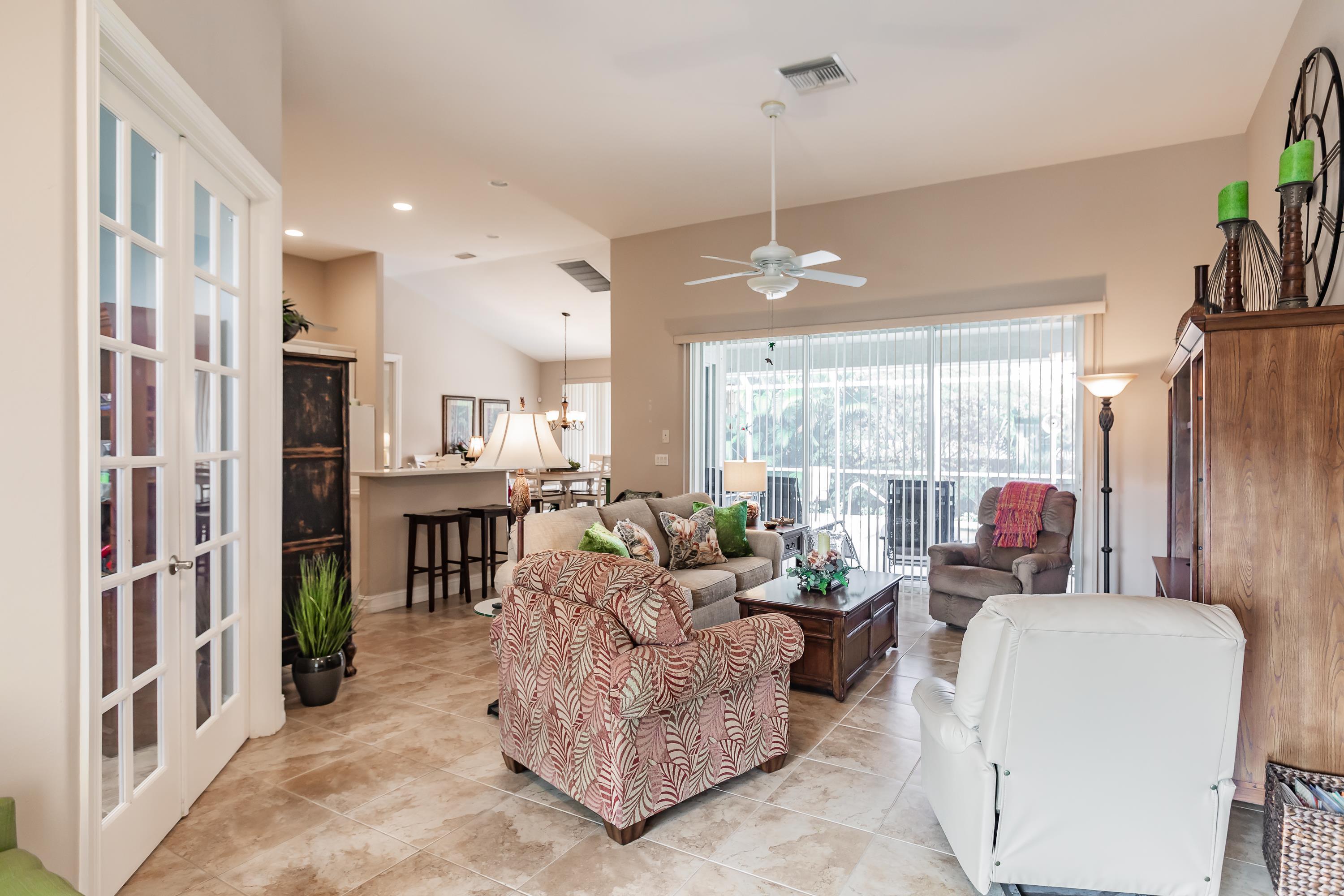 31 Tahiti Road Marco Island, FL 34145 - Photo 9 of 31 a living room with furniture and a chandelier