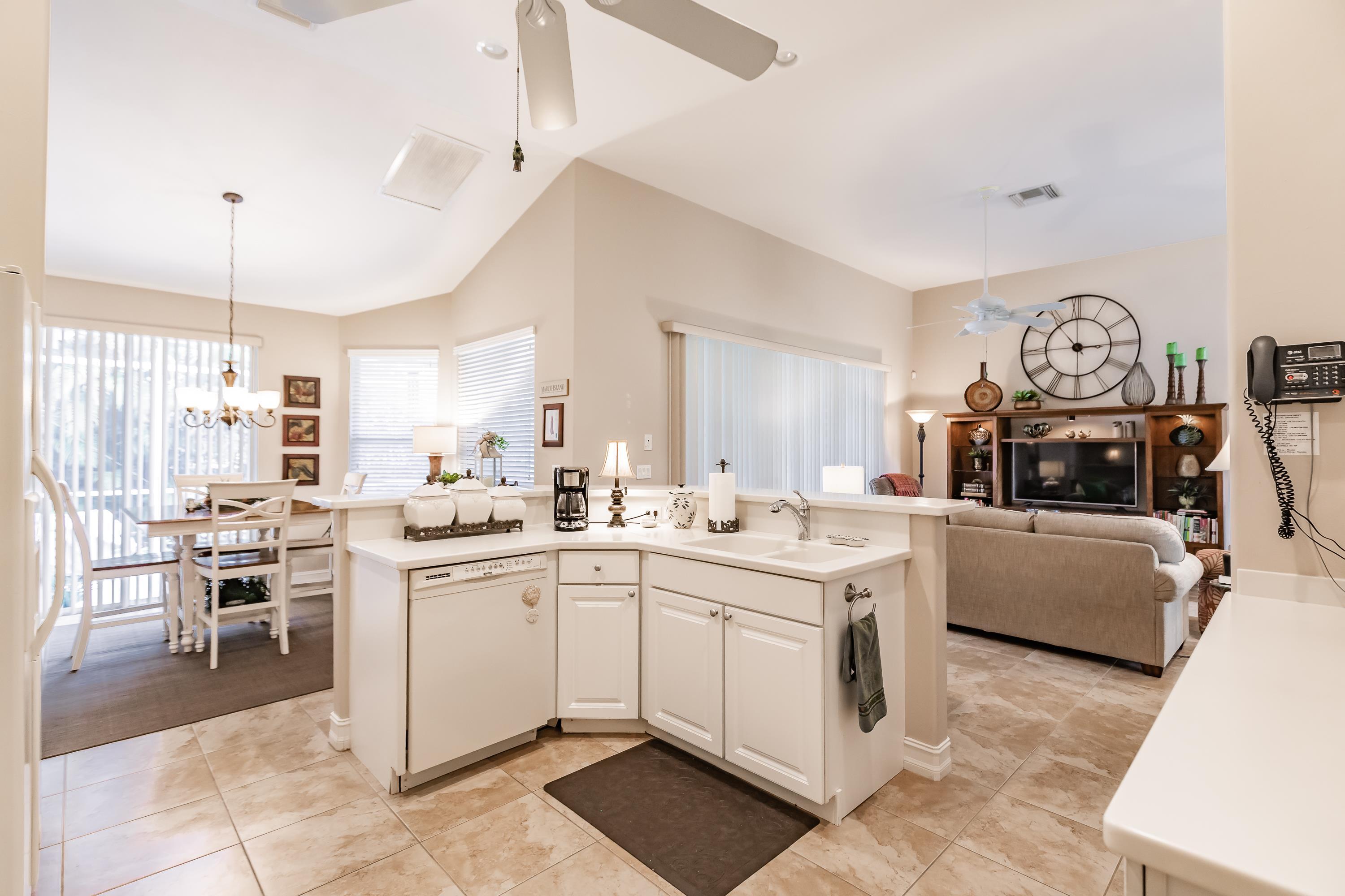 31 Tahiti Road Marco Island, FL 34145 - Photo 10 of 31 a kitchen with a sink stove and cabinets
