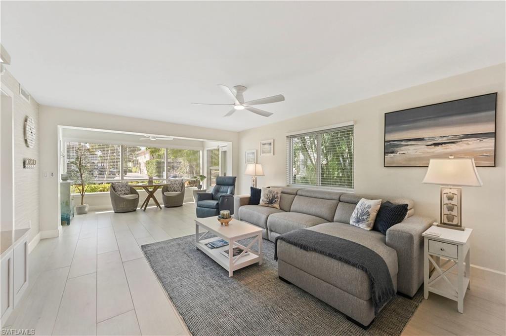 1686 Blue Point Avenue, Unit B5 Naples, FL 34102 - Photo 12 of 46 a living room with furniture and a large window