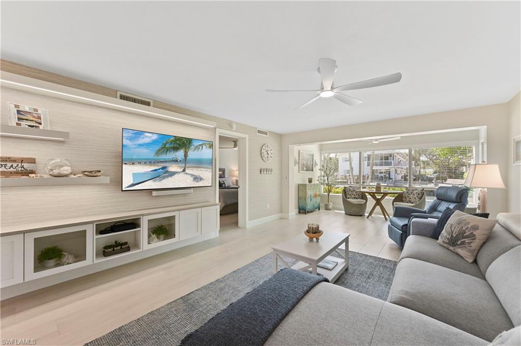 1686 Blue Point Avenue, Unit B5 Naples, FL 34102 - Photo 13 of 46 a living room with furniture and a flat screen tv