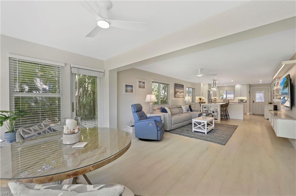 1686 Blue Point Avenue, Unit B5 Naples, FL 34102 - Photo 14 of 46 a living room with furniture and floor to ceiling windows