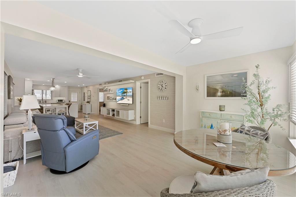 1686 Blue Point Avenue, Unit B5 Naples, FL 34102 - Photo 15 of 46 a living room with furniture and a dining table