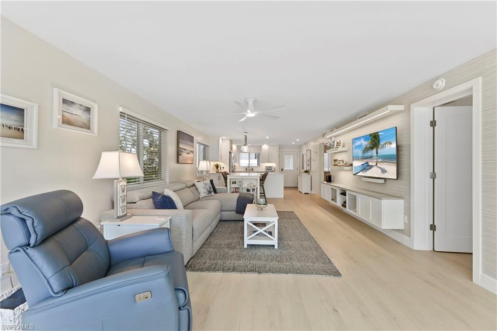1686 Blue Point Avenue, Unit B5 Naples, FL 34102 - Photo 17 of 46 a living room with furniture and a flat screen tv