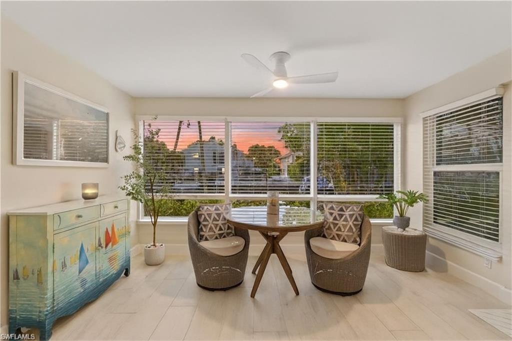 1686 Blue Point Avenue, Unit B5 Naples, FL 34102 - Photo 18 of 46 a living room with furniture and floor to ceiling windows